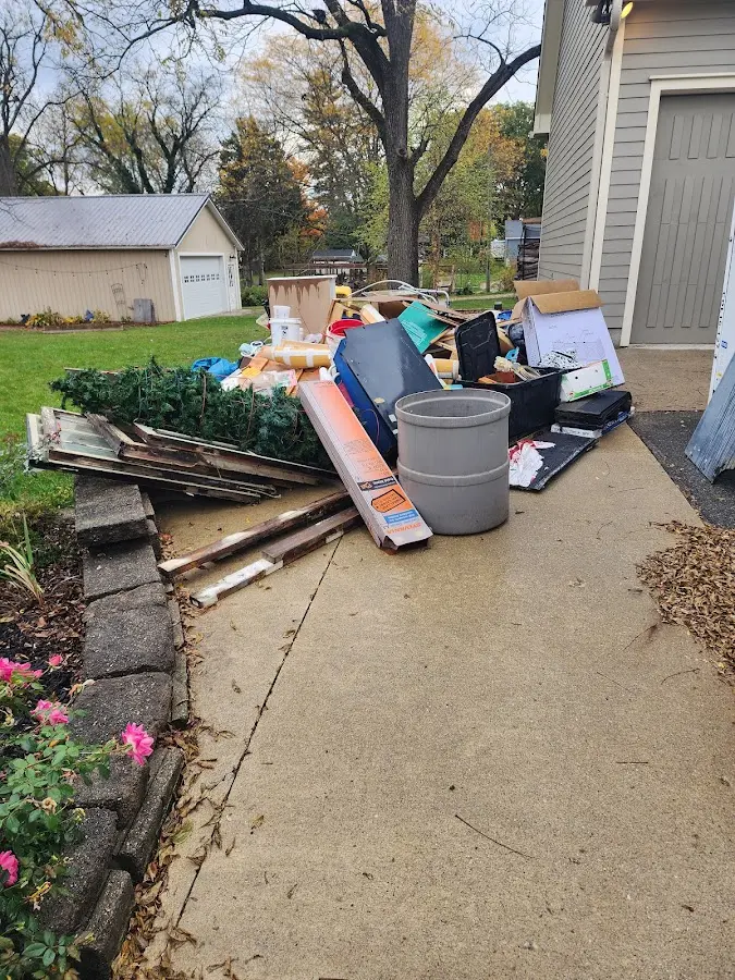 Dumpster being loaded with debris for Estate Cleanout Dumpster Rental in Monongahela